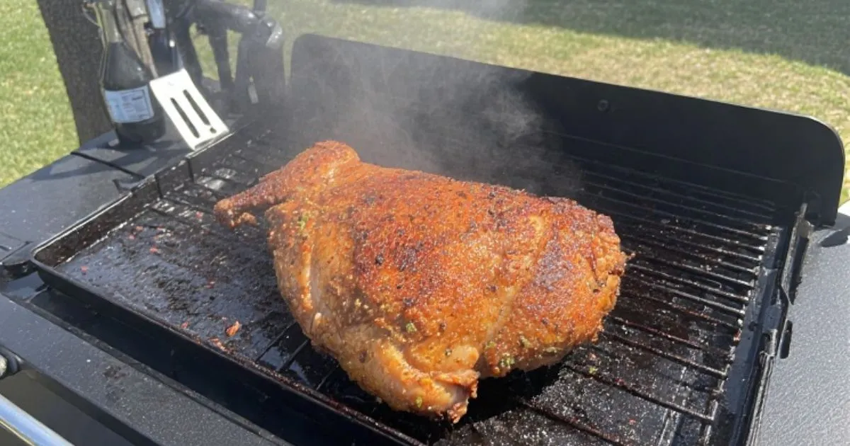 Juicy chicken breasts searing on a Blackstone griddle with a golden-brown crust forming. 