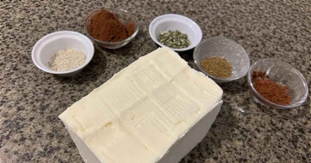 Preparing cream cheese for smoking by scoring and seasoning for enhanced flavor.