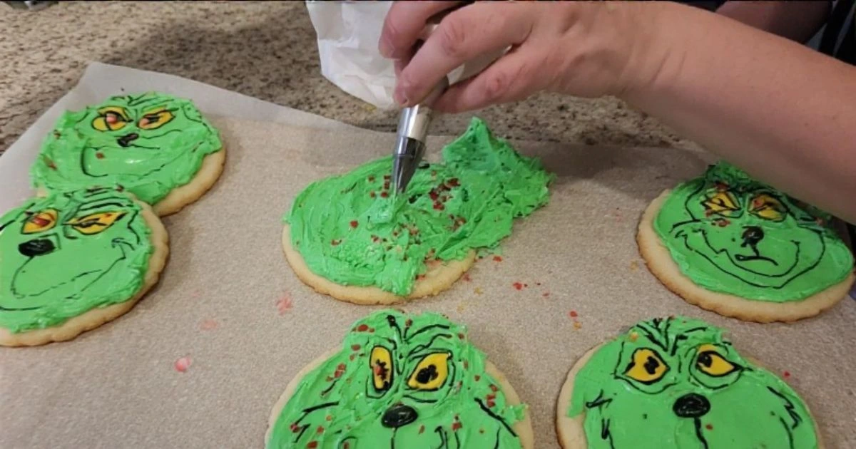 Decorating Grinch cookies recipe with vibrant green frosting for a festive holiday look.