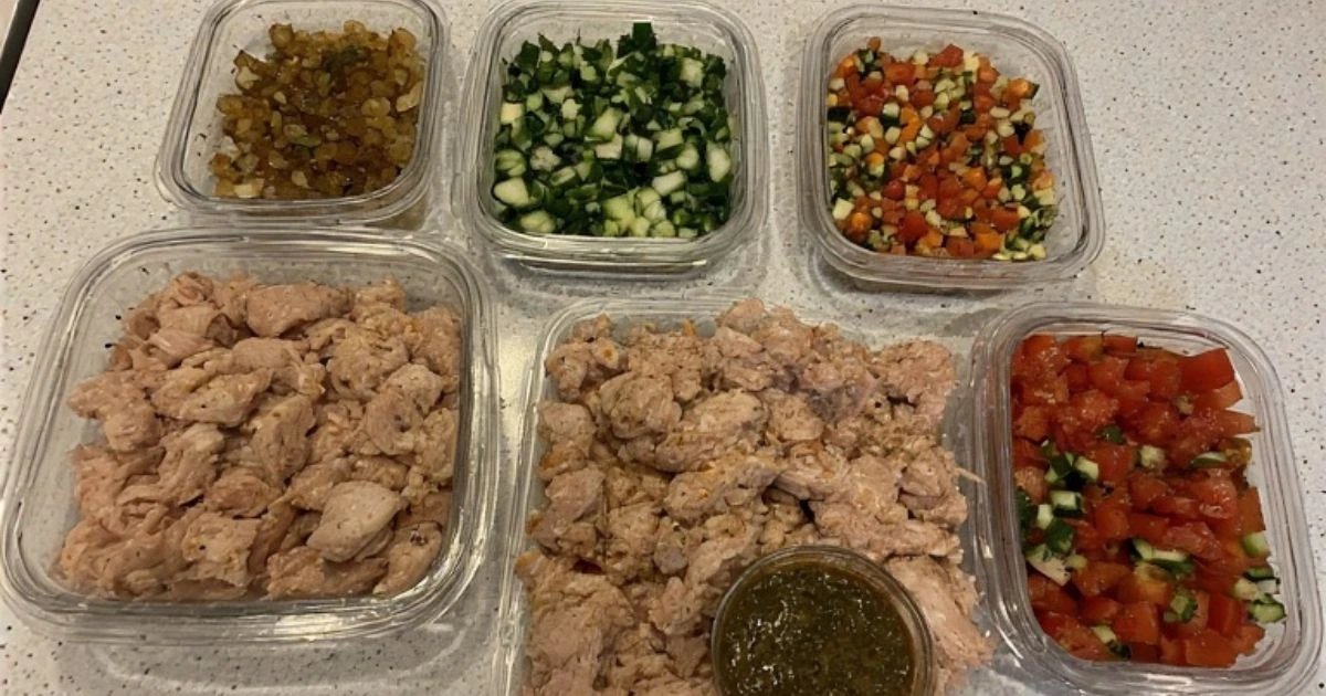 Meal prepping quick chicken meals with pre-cooked chicken and chopped vegetables for easy weeknight dinners.