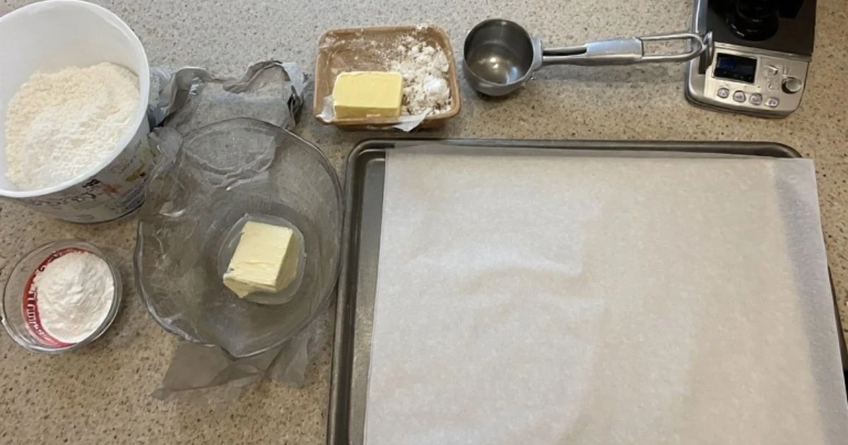 Essential tools and equipment for making the homemade Crumbl cookies recipe, including a stand mixer and cookie scoop.